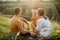 Family with little daughter rests in the meadow