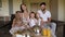 A family with a little son and twin daughters have Breakfast in a hotel room.