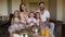 A family with a little son and twin daughters have Breakfast in a hotel room.