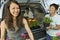 Family loading flowers into SUV