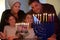 Family looking at candelabrum on the eight day of Hanukkah Jewish holiday festival
