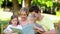 Family looking a picture book on a bench