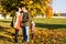 Family in love walks in autumn park