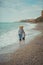 Family lovely scene of beautyful mother posing kissing her cute handsome son on beach sea side during summer vacation on ocean res