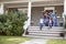 Family With Luggage Leaving House For Vacation