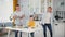 family lunch, joyful caring parents together with their young son set table for joint dinner in background of kitchen