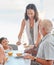 Family, lunch and woman serve food to father in the family home at the dining table for nutrition, diet and wellness