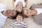 Family lying on floor with heads together