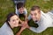 Family lying on garden with hands together