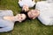 Family lying on garden with heads together