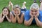 Family lying in grass, father mother and daughter