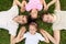 Family lying on grass, view from top