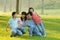 Family lying outdoors being playful and smiling