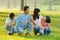 Family lying outdoors being playful and smiling