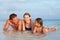 Family Lying In Sea On Tropical Beach Holiday