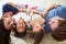 Family Lying Upside Down On Bed In Pajamas Together