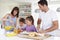 Family Making Breakfast In Kitchen Together