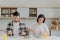 Family married couple pose at kitchen table, have delicious breakfast, talk about plannings on day, eat fried eggs and burgers,