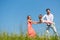 Family on meadow playing with their little daughter