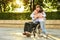 Family meeting. A man and a boy came to see their grandfather who sits in a park on a wheelchair