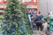 Family members shopping for artificial Xmas tree and toys at hardware store in USA