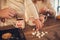 Family: mom, dad and daughter in white sweaters cook and drink cocoa with marshmallows. Closeup hands and cups. Christmas concept