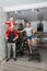 Family mom, dad and son in Santa costume fool around and play near the Christmas tree in their apartment