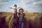 Family mom dad son stand in a sloping field near the haystacks