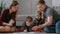 Family mom, dad and two twin brothers draw together markers and felt pens sitting on the floor.