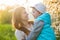 Family mom with daughter woman with child in spring stand and hug