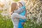 Family mom with daughter woman with child in spring stand and hug