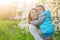 Family mom with daughter woman with child in spring stand and hug