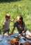 Family mom and son on picnic. Smiling and enjoying summer on blanket in park.