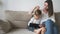 Family mother and child using tablet sitting on sofa at home