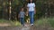 Family: mother and child walk in the forest or Park, enjoying nature. A happy mother holds her son`s hand and walks down