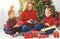 Family mother and children open presents on Christmas morning