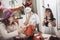 Family of mother and children prepare for Halloween pumpkins decorate the home