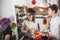 Family of mother and children prepare for Halloween pumpkins decorate the home