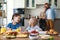 Family mother father and children have Breakfast in kitchen in morning