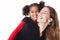 A family mother with girl child posing on a white background studio