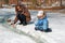 Family of mother with kid playing in the snow spring forest