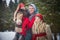 Family with mother, teenage girl, and little daughter dressed in stylized medieval peasant clothing in winter forest