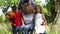 Family with a mother in a wheelchair making a family portrait standing in the nature, children hugging their mother kiss