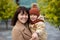 Family, motherhood, love and happiness concept - happy mother and her little daughter in autumn park