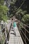 Family In Mountains Crossing Bridge