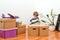 Family moves into a new apartment. Boy playing with toys in new room. Cute kid helping unpacking boxes