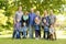 A Family and multi-generation mother, father, children and grandmother having fun on meadow in summer