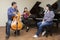 Family music trio. A young violinist and cellist play, the pianist accompanies them