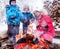 Family near bonfire in winter landscape