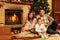 Family near fireplace in Christmas house